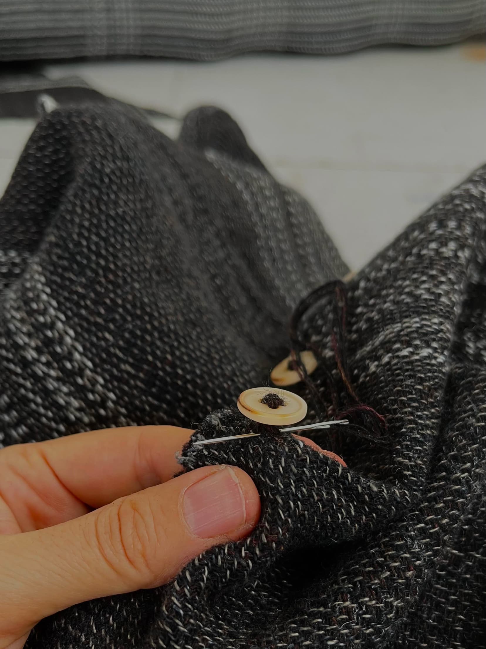 Isabella sewing buttons