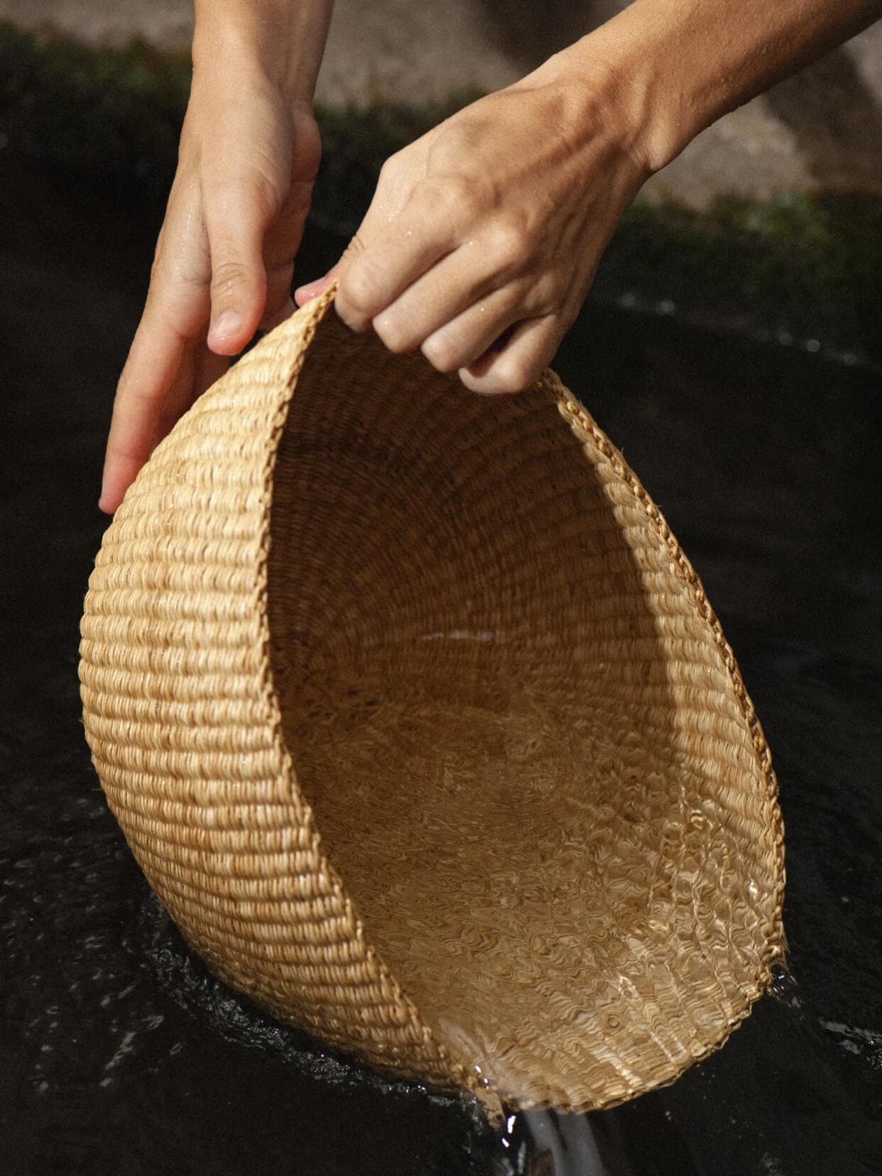 The prototype of the bag, woven in Ghana, is reshaped after being soaked in water.